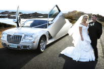 Silver Chrysler wedding cars Perth with bride and groom for a Busselton wedding. Silver Chrysler wedding limo.